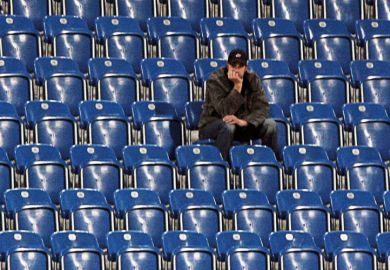Man sitting alone in empty stadium Man sitting alone in empty stadium