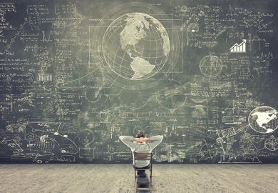 Man sitting on chair looking at blackboard full of scientific figures and graphs