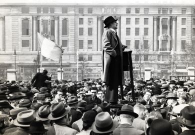 Man speaking to large crowd of people