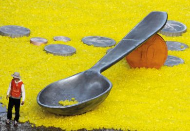 Man standing with giant spoon and coins, World Vision charity event Man standing with giant spoon and coins, World Vision charity event