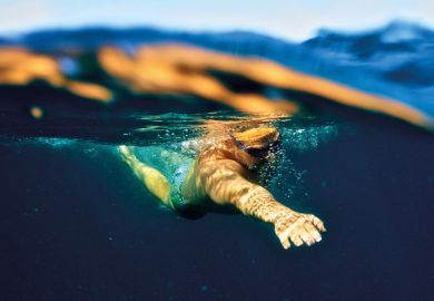 Man swimming underwater in ocean