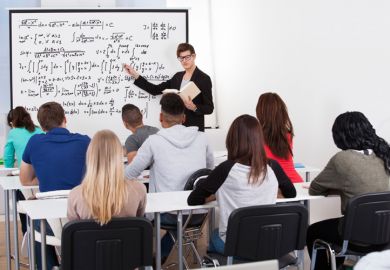 Man teaching mathematics to class of students