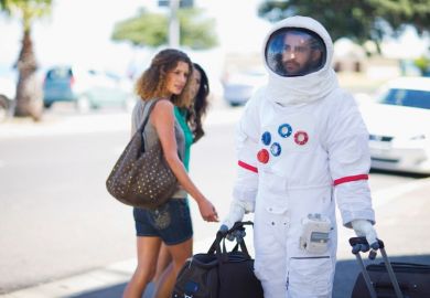 Man walking on street dressed as astronaut Man walking on street dressed as astronaut