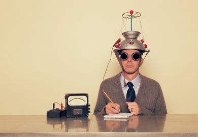 Man with colander on his head connected to electrodes