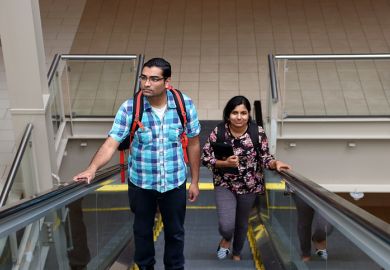 Man and woman going up escalator