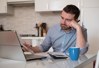 Man frustrated by paperwork Man frustrated by paperwork