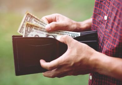 Man getting dollar notes out of wallet