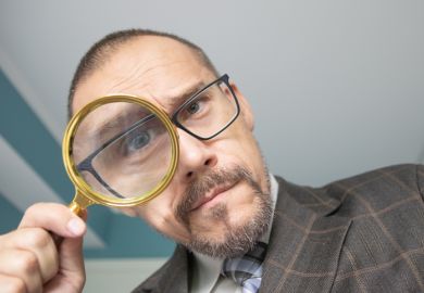 Man looking through a magnifying glass Man looking through a magnifying glass