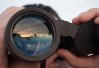 Man looking through binoculars illustrating op-ed by Stephen Toope about University of Cambridge principles around international engagement
