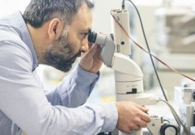 man looking through microscope man_looking_through_microscope