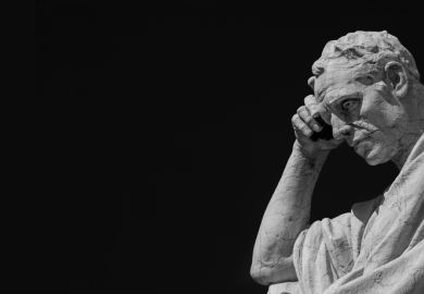 Man statue in the act of thinking against blue sky. Ancient Roman Julian the Jurist statue made at the end of 19th century in front of the Old Palace of Justice in Rome