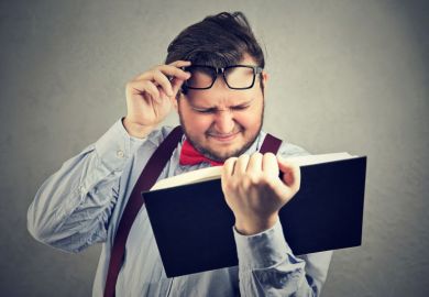 Man struggling to read book