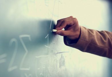 Man's hand drawing on blackboard