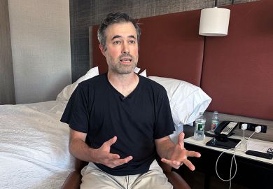 Mark Bray, a Rutgers assistant professor of history, waits in a hotel room in Newark, N.J., before a planned flight to Spain on Thursday, 9 October, 2025.