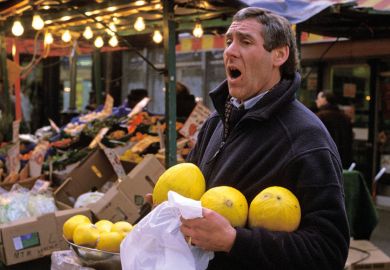 Market trader selling fruit, London