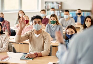 Masked students in a classroom illustrating an opinion article about returning to in-person teaching