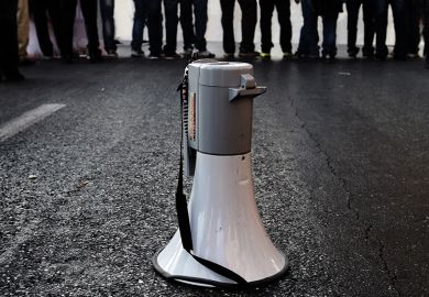Megaphone on road in front of crowd of people Megaphone on road in front of crowd of people