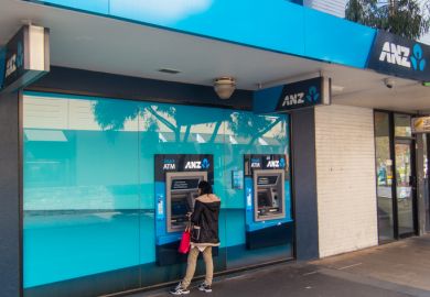 Melbourne, Australia - August 22, 2014 a woman accessing cash from the automatic teller machine outside the Box Hill branch of the ANZ Bank in suburban Melbourne. The ANZ is Australia's third largest bank by market capitalization.