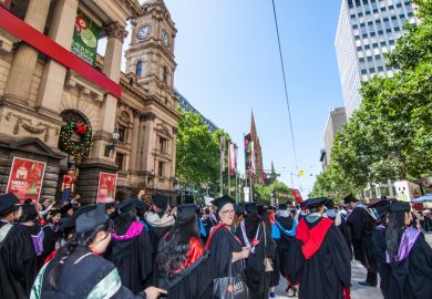 Melbourne, Australia - December 17, 2014 - RMIT university graduation day - the students walk along the Swanton St in Melbourne city for celebration day in graduation day