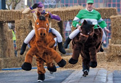 Men competing in pantomime horse race, Birmingham Men competing in pantomime horse race, Birmingham
