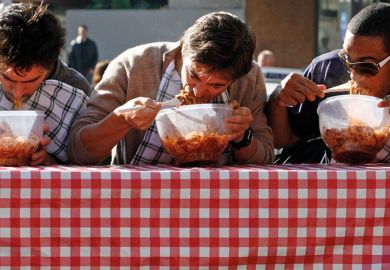 Men eating pasta in speed eating competition