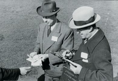 Men paying out winnings at a racecourse