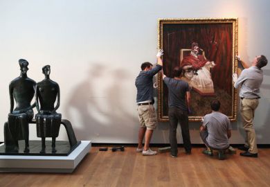 Men hanging painting on gallery wall Men hanging painting on gallery wall