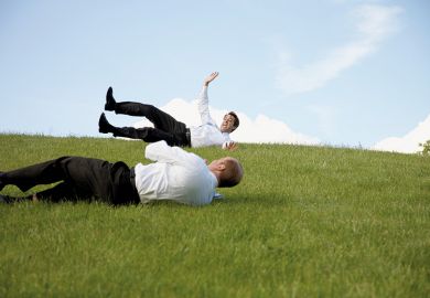 Men rolling down a hill