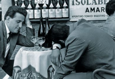 Men slumped at table Men slumped at table