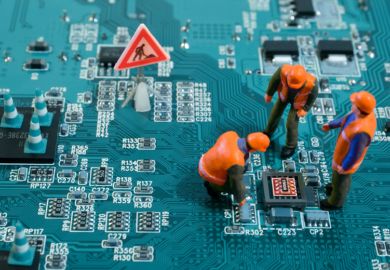 Figures of humans stand and squat on a motherboard Figures of humans stand and squat on a motherboard