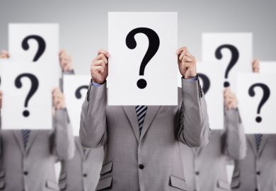 Men in suits holding question marks