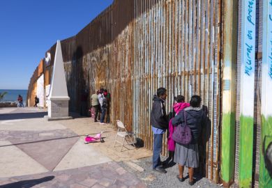 Mexican families living in Tijuana visit family members living in the US at the border wall in Playas de Tijuana