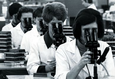 Team of researchers with microscopes