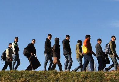 Migrants walking to registration point, Germany Migrants walking to registration point, Germany