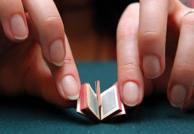 Person reading miniature book