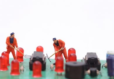 Miniature technicians repair a computer