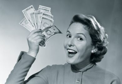 Woman holds up money