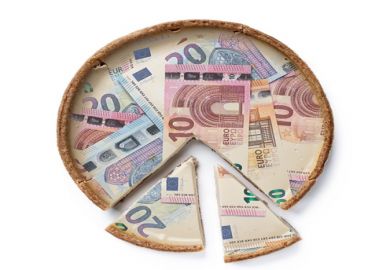 A pie made of Euro notes with cut slices at the bottom A pie made of Euro notes with cut slices at the bottom