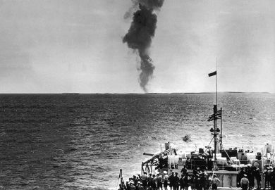 The crew of the HMS Narvik watch the smoke rise after a British atomic test, which took place on the Montebello Islands off the west coast of Australia, 16 May 1956.