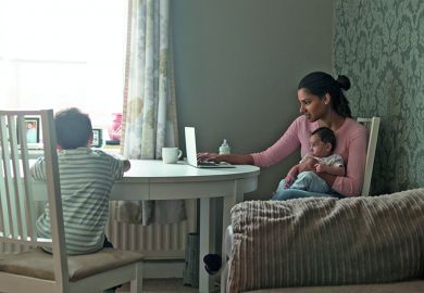 mother with child in front of a laptop computer