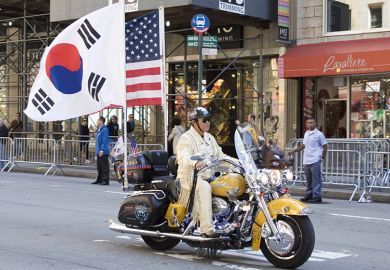 Korean Day Parade along Avenue of the Americas in New York, USA. Motorbike with American and Korean flags