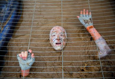 Muddy obstacle in Tough Mudder race