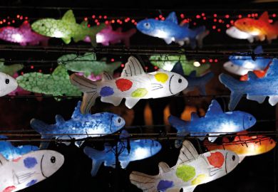 Multi-coloured fish lanterns hanging on wire Multi-coloured fish lanterns hanging on wire