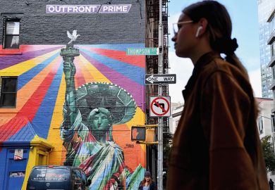 Woman walking past a mural