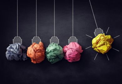 A Newton's cradle with crumpled paper lightbulbs A Newton's cradle with crumpled paper lightbulbs, one of which is lit, symbolising ideas for efficiency