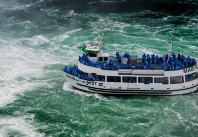 Niagara Falls, NY, USA - June 13, 2019 Ship with tourists moves to Niagara falls, Falls boat tour experience is North America oldest attraction, and has drawn millions of visitors since 1846