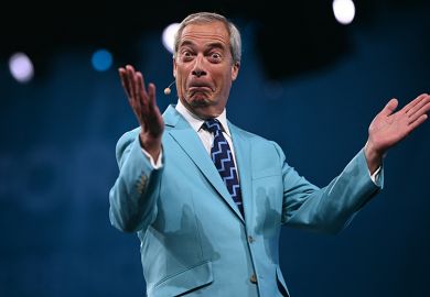 Reform UK Leader Nigel Farage reacts while performing on the first day of the Reform UK party conference at the NEC Birmingham, central England, on 5 September, 2025
