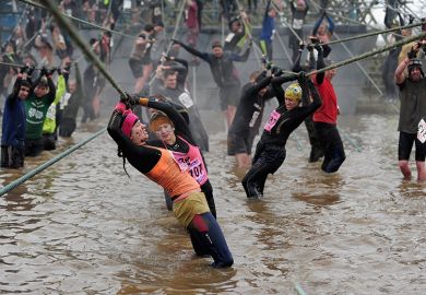 Competitors tackle a rope bridge during the Tough Guy Challenge endurance race. To illustrate that universities are calling “stability” from government policy regarding international students, with the graduate route visa apparently at risk.