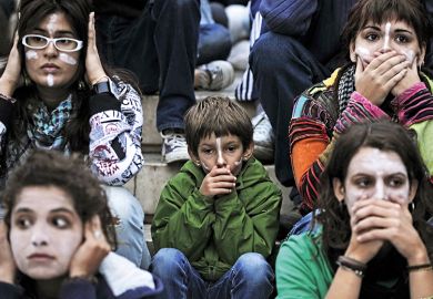 At an Occupy protest, people cover their mouths and ears