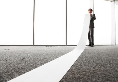 Office worker unrolling long sheet Office worker unrolling long sheet